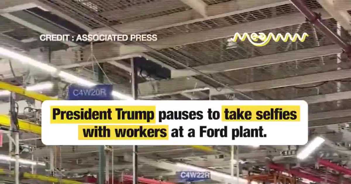 President Trump pauses to take selfies with workers at a Ford plant.