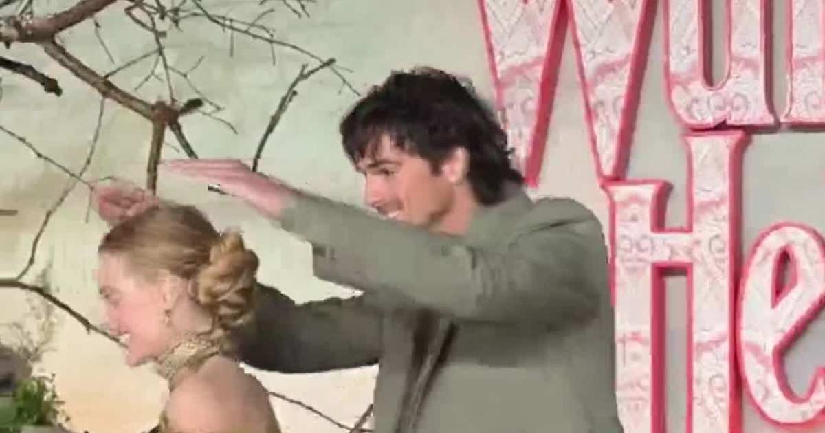 Jacob Elordi Shields Margot Robbie in the Rain at 'Wuthering Heights' UK Premiere